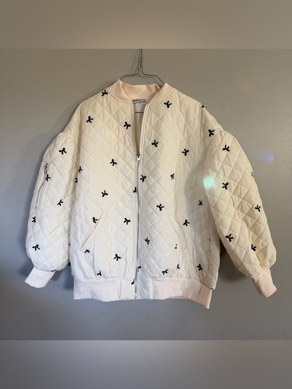 Katydid Cream Quilted Bomber Jacket with Black Bow Accents